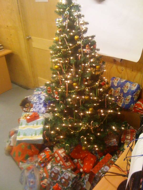Gy Sgt Thomas Conklin ,Marine with their tree and gifts from ASWL