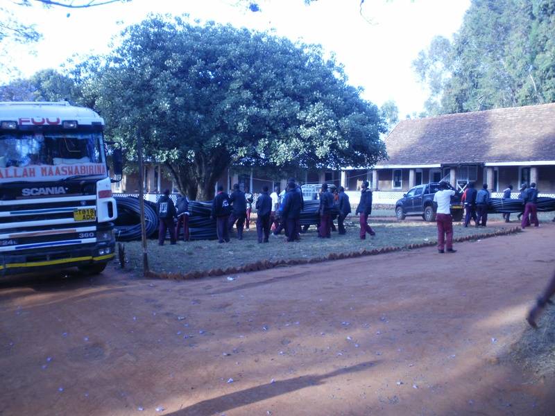 Secondary School students unloading pipe at the Mission House