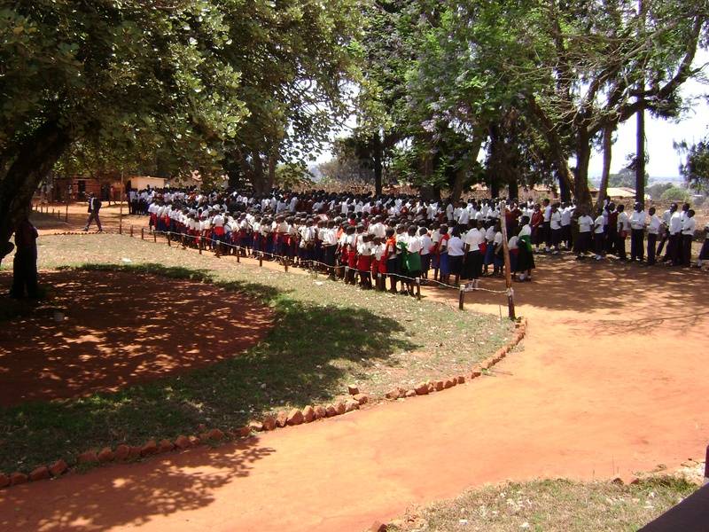 The Primary School students prepare to join the large procession from the Mission House to the water tank platform
